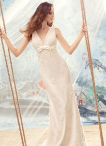 Style #1708L, beaded lace sheath wedding dress with bow detail on the plunging neckline top, available in ivory