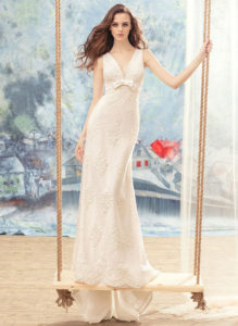 Style #1708L, beaded lace sheath wedding dress with bow detail on the plunging neckline top, available in ivory