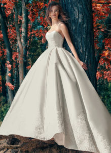 Style #1747L, strapless Mikado ball gown wedding dress with lace details and side pockets, available in white, ivory