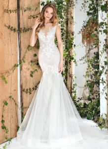 Style #1810L, fit and flare silhouette wedding gown with lace embroidery, illusion plunging neckline, and keyhole back, available in ivory and light pink