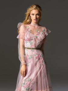Style #341, long sleeve evening dress features an illusion high neck with ruffled details, and flower embroidered lining dress with the sheer overlay skirt, available in pink-ivory
