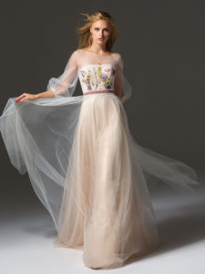 Style #343, long evening gown with an illusion neckline, three-quarter length bishop sleeves, floral embroidery, and velvet belt, available in grey, pink-ivory, ivory