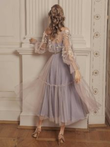 Style #505, off-the-shoulder midi dress with floral embroidery and bishop sleeves, available in powder, grey-pink, nude, peach