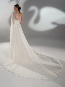 Style #2101, A-line wedding dress with one-shoulder cape sleeve, available in ivory