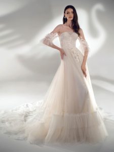 Style #2122, three-quarter sleeve A-line wedding dress with ruffles, available in cream-nude, ivory