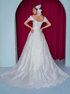 Style #2231L, organza ball gown with off the shoulder straps and floral decor, available in ivory
