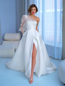 Style #2215L, one-sleeve ball gown wedding dress with high slit and pockets, available in ivory