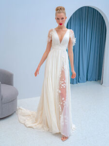 Style #2226L, flutter sleeve chiffon dress with a high slit and 3D floral decor, available in ivory