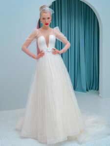 Style #2200L, A-line wedding dress with a plunging neckline, long sleeves and puffed shoulders, available in ivory