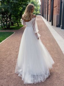 Ball gown wedding dress with asymmetric neckline and long sleeves