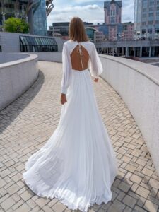 Chiffon wedding dress with cut-outs and floral accent