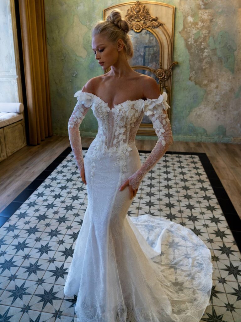 A bride in a stunning off-the-shoulder wedding dress with floral lace details, highlighting the romantic aspects of the 2025 wedding dress trends.