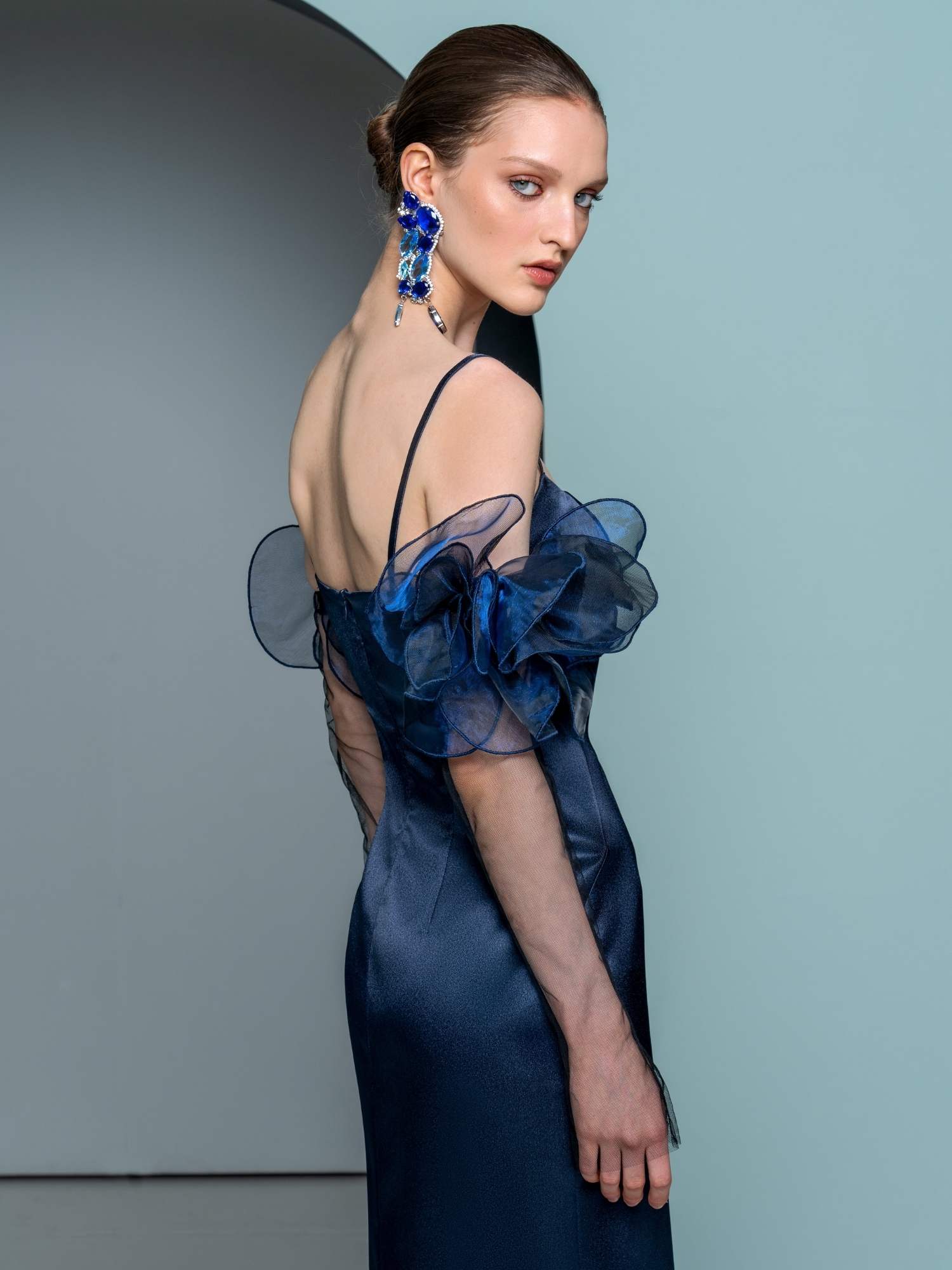 Sophisticated navy evening dress with sheer floral accents and a modern silhouette, part of Papilio Boutique’s evening dresses on sale collection in Toronto.