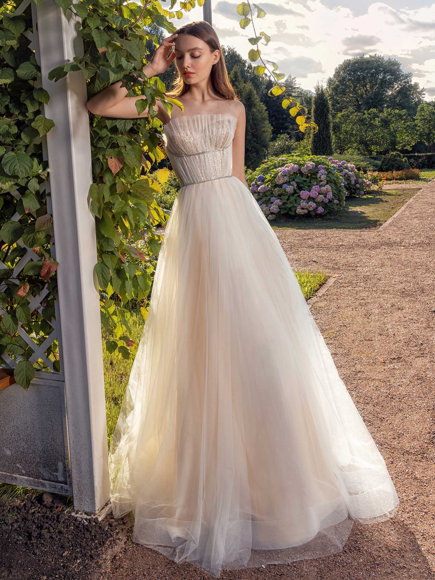 Best Wedding Dress for Body Type - Small Chested: Romantic strapless A-line wedding dress with a pleated sheer bodice and soft tulle skirt, designed to enhance and flatter a smaller bust. Available at Papilio Boutique in Toronto.