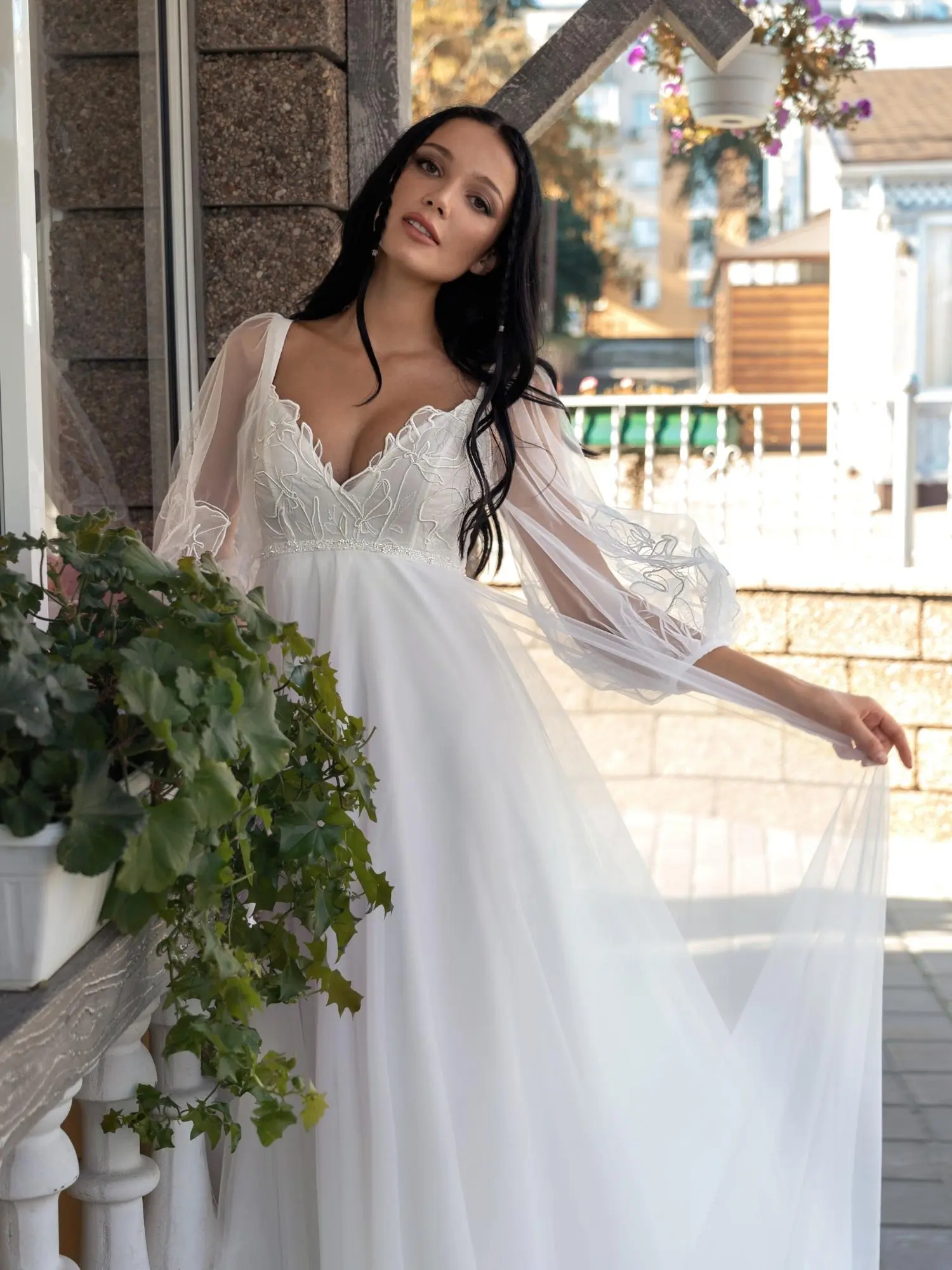 Best Wedding Dress for Body Type - Apple Shaped: Flowing A-line wedding dress with sheer bishop sleeves, plunging V-neckline, and delicate lace bodice, designed to flatter fuller midsections. Available at Papilio Boutique in Toronto.