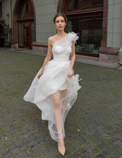 Elegant organza wedding gown with a flowy skirt and delicate shoulder appliqué, by Papilio Boutique Toronto bridal store.