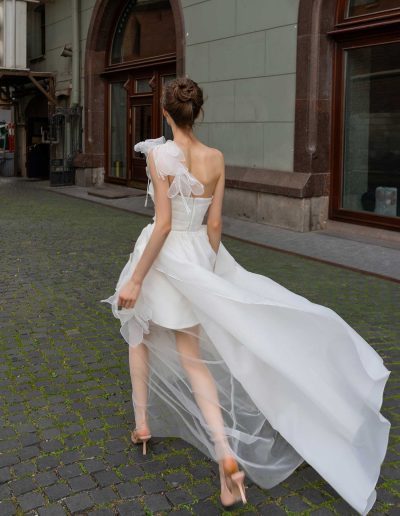 Back view of a romantic organza wedding dress with cascading layers, by Papilio Boutique Toronto bridal store.