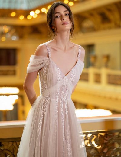 Front view of a romantic A-line bridal dress with capes and delicate embroidery, by Papilio Boutique Toronto bridal store.