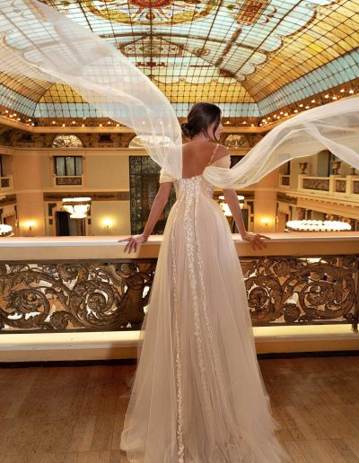 Bride in an A-line bridal gown with ethereal capes, intricate back detailing, by Papilio Boutique Toronto bridal store.