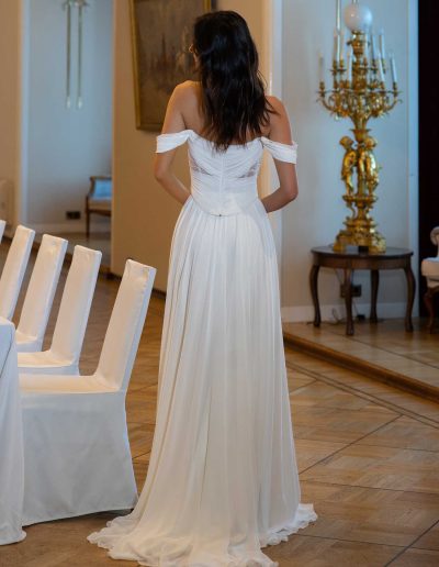 Back view of a drop waist wedding dress with a subtle leg slip, showcasing intricate designs, by Papilio Boutique Toronto bridal store.