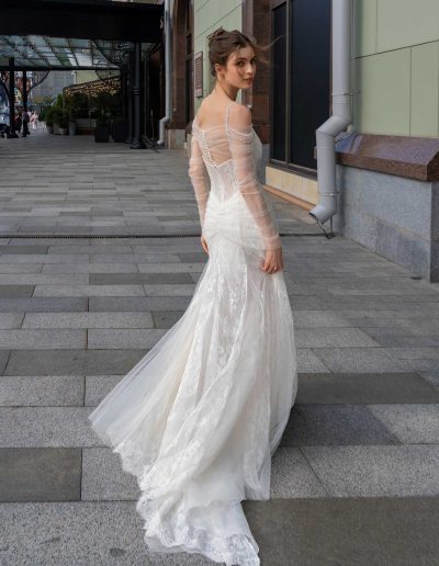 Elegant back view of a unique wedding dress with a sheer bodice and detailed beading, by Papilio Boutique Toronto bridal store.