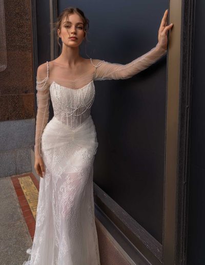 Unique wedding dress with sheer sleeves and delicate embellishments, by Papilio Boutique Toronto bridal store.