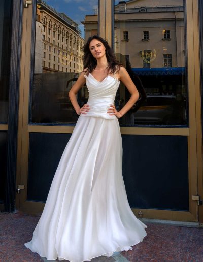 Lightweight organza wedding gown with spaghetti straps, featuring a ruched bodice, by Papilio Boutique Toronto bridal store.