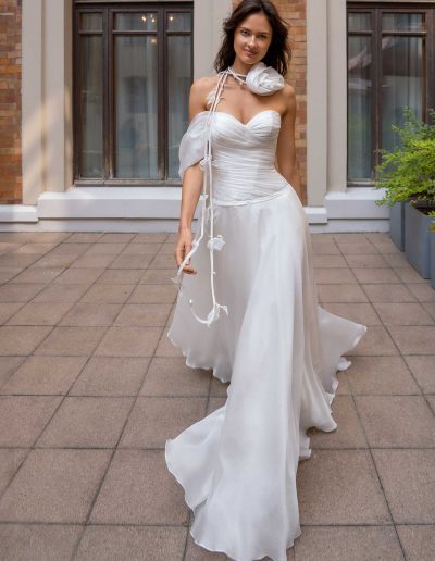 Bride in a sophisticated organza wedding gown with asymmetrical shoulder, perfect for a modern wedding, by Papilio Boutique Toronto bridal store.