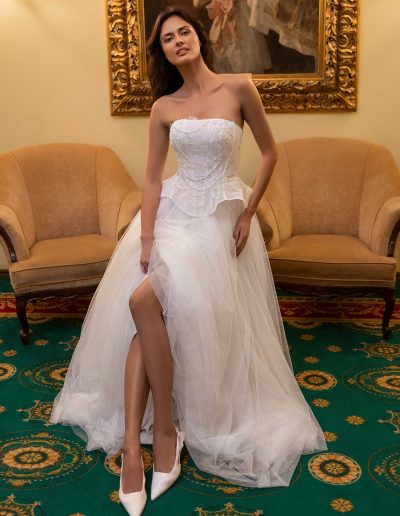 Bride in a sophisticated corset and skirt ensemble by Papilio Boutique Toronto bridal store, lounging elegantly.