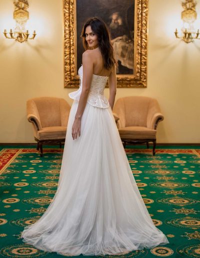 Rear view of a bridal corset and skirt outfit by Papilio Boutique Toronto bridal store, showcasing delicate lace and flowing skirt.