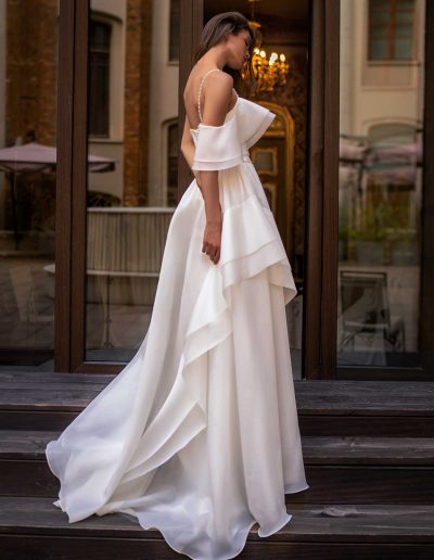 Back view of an organza bridal gown with voluminous off-the-shoulder detail, by Papilio Boutique Toronto bridal store, showcasing elegant tailoring.