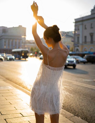 Back view of a fashionable mini wedding dress with delicate fringe by Papilio Boutique Toronto bridal store.