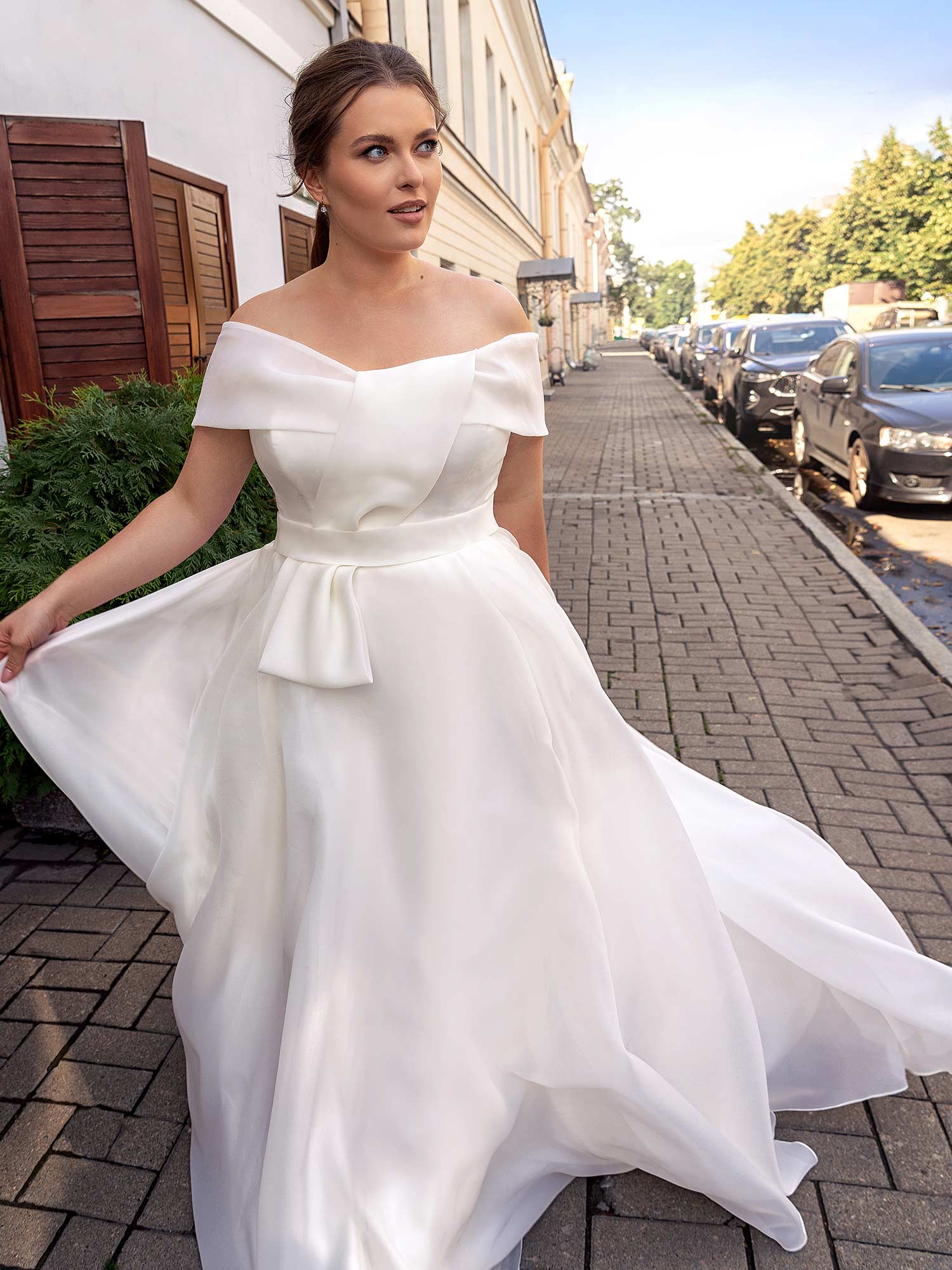 Graceful A-line wedding dress with a pleated chiffon skirt, deep V-neckline, and embroidered shoulder accents, perfect for complementing apple-shaped figures. The Best Wedding Dress for Body Type - Apple Shaped is available at Papilio Boutique in Toronto.