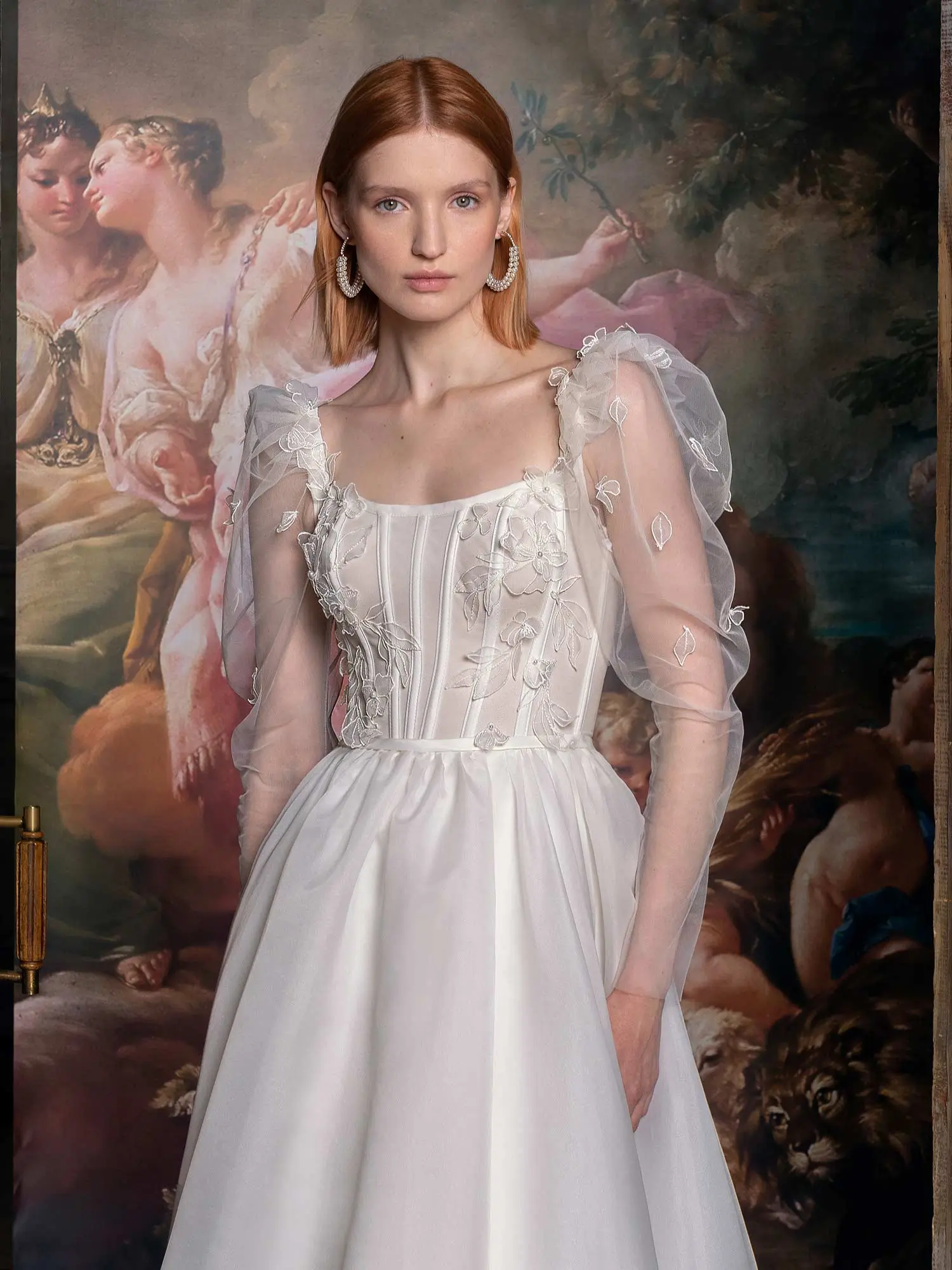 Romantic A-line wedding dress with sheer puff sleeves, embroidered floral details, and a square neckline, designed to flatter pear-shaped brides. Find the Best Wedding Dress for Body Type at Papilio Boutique in Toronto.