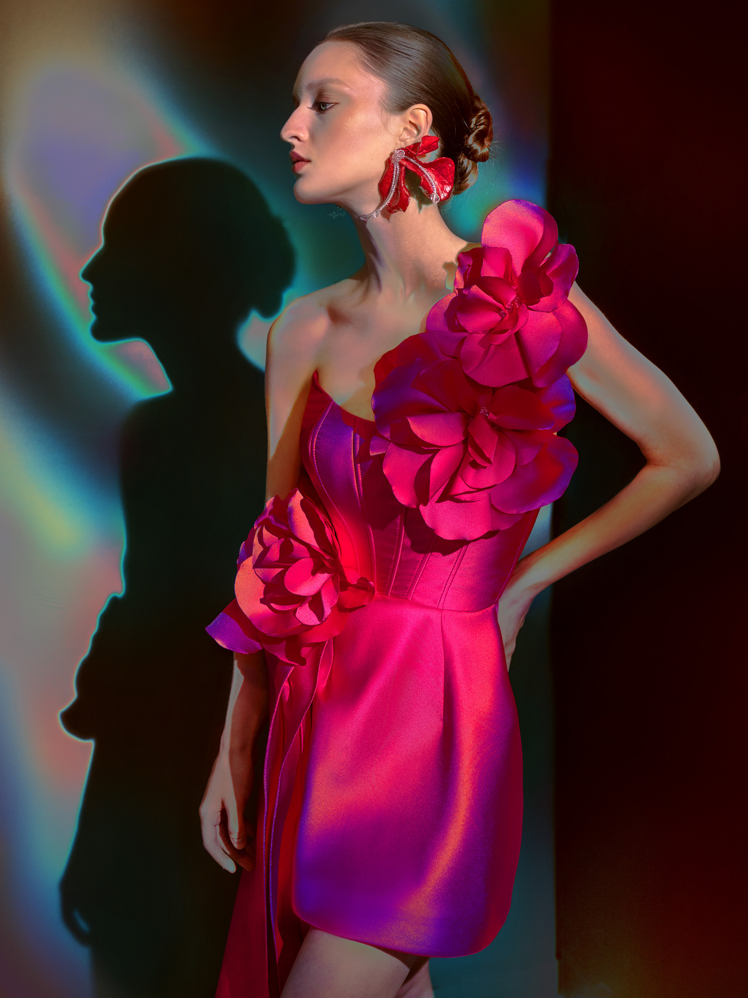 Vibrant fuchsia evening dress with bold floral appliqués and corset detailing, available in Toronto. Explore exclusive evening dresses on sale at Papilio Boutique.