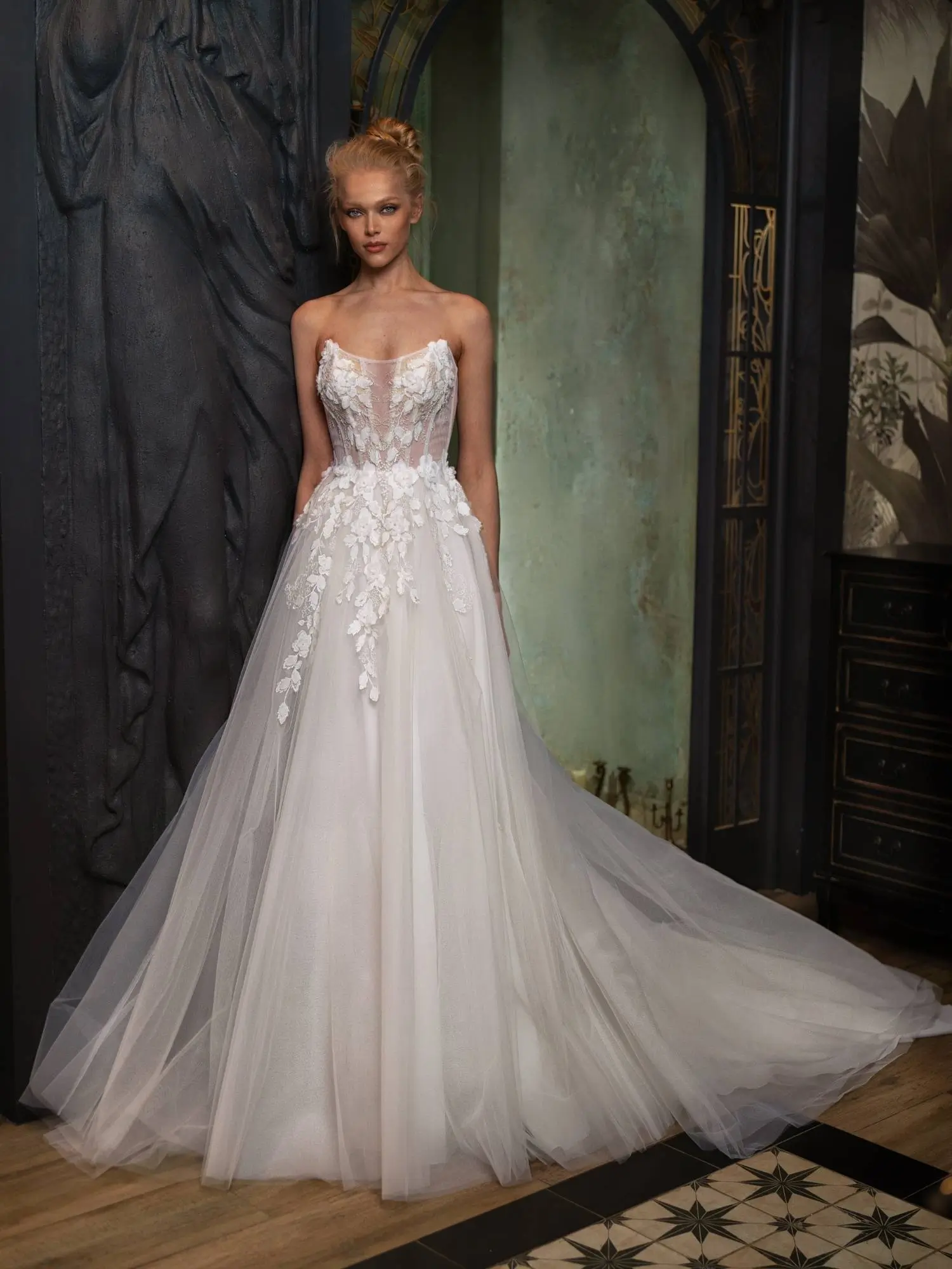 Best Wedding Dress for Body Type - Petite: Strapless A-line wedding dress with a sheer corset bodice, floral appliqués, and a voluminous tulle skirt, perfect for elongating a petite frame. Available at Papilio Boutique in Toronto.